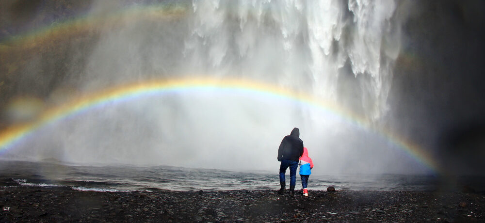 dad and kid are under the rainbow e1632464917649