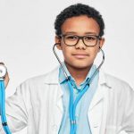 portrait of african american male kid wearing a doctor coat e1618468282226