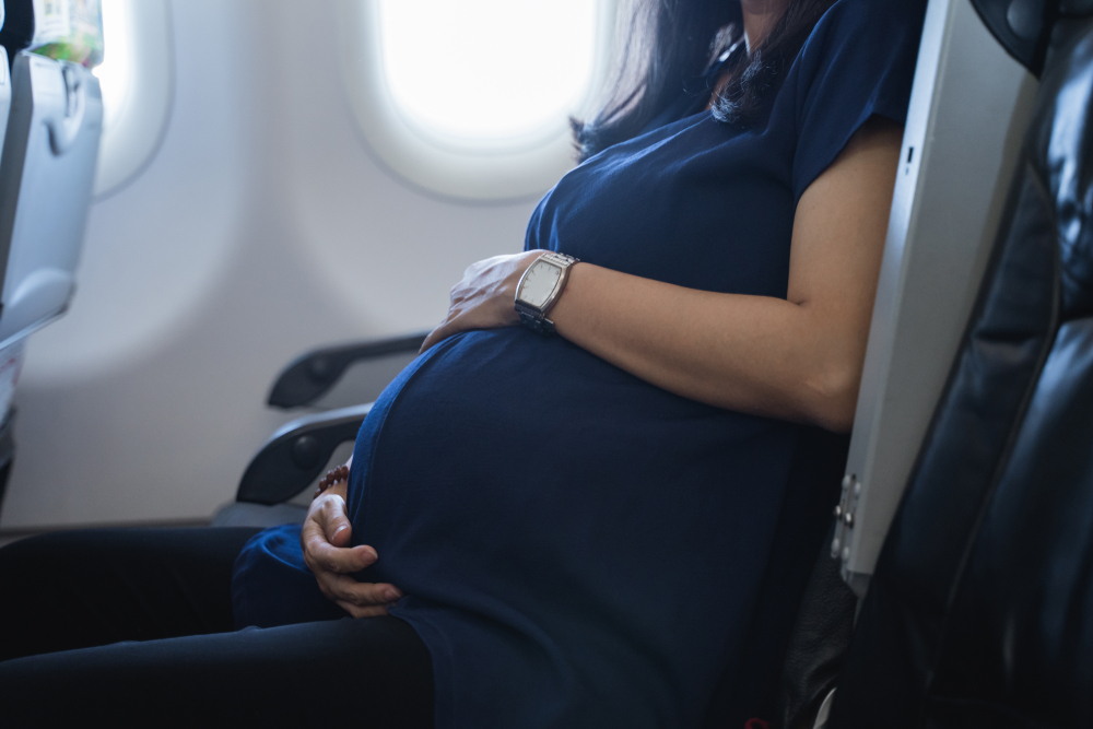 pregnant woman in airplane cabin